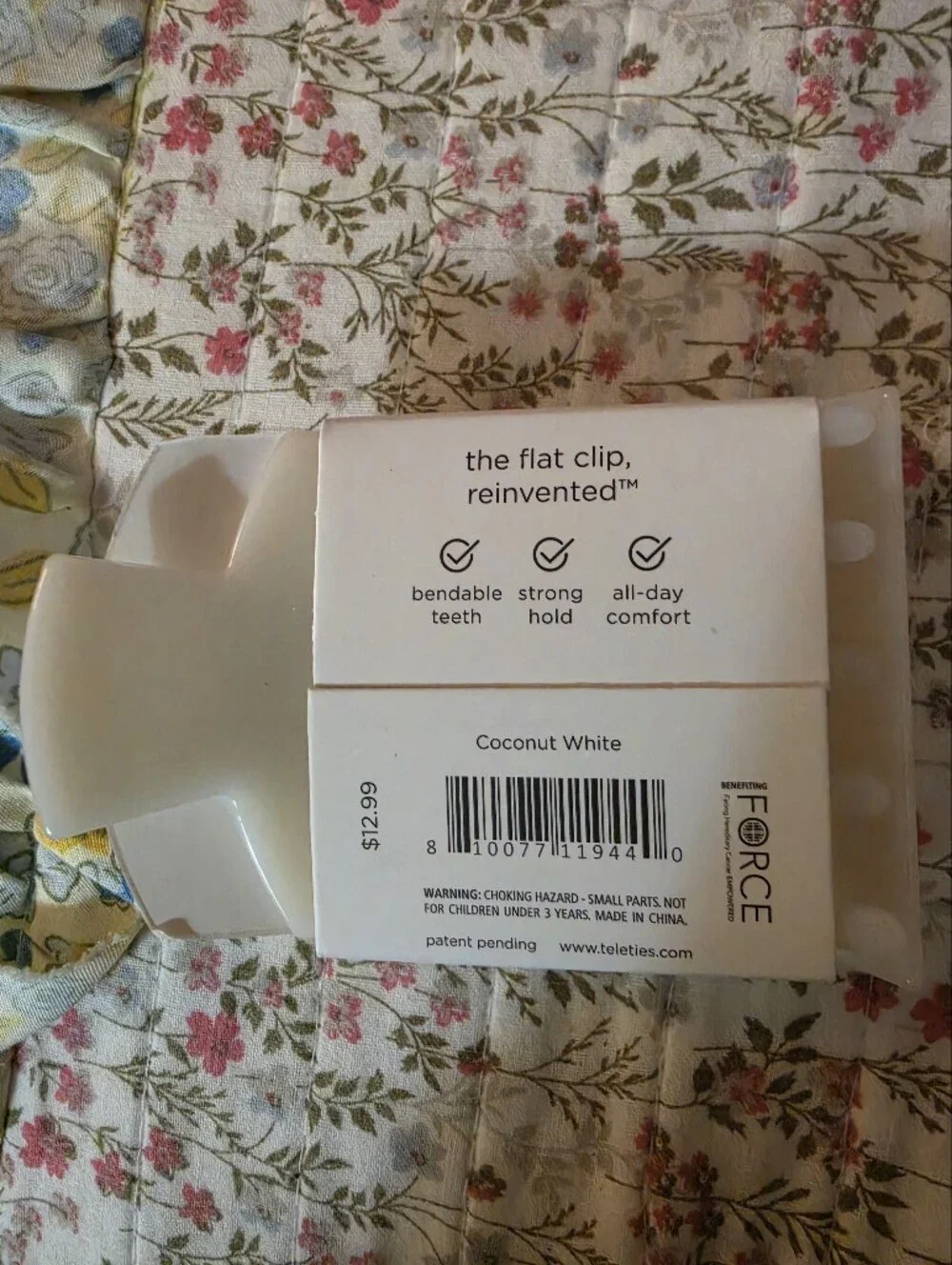 Coconut white plastic hair clip.